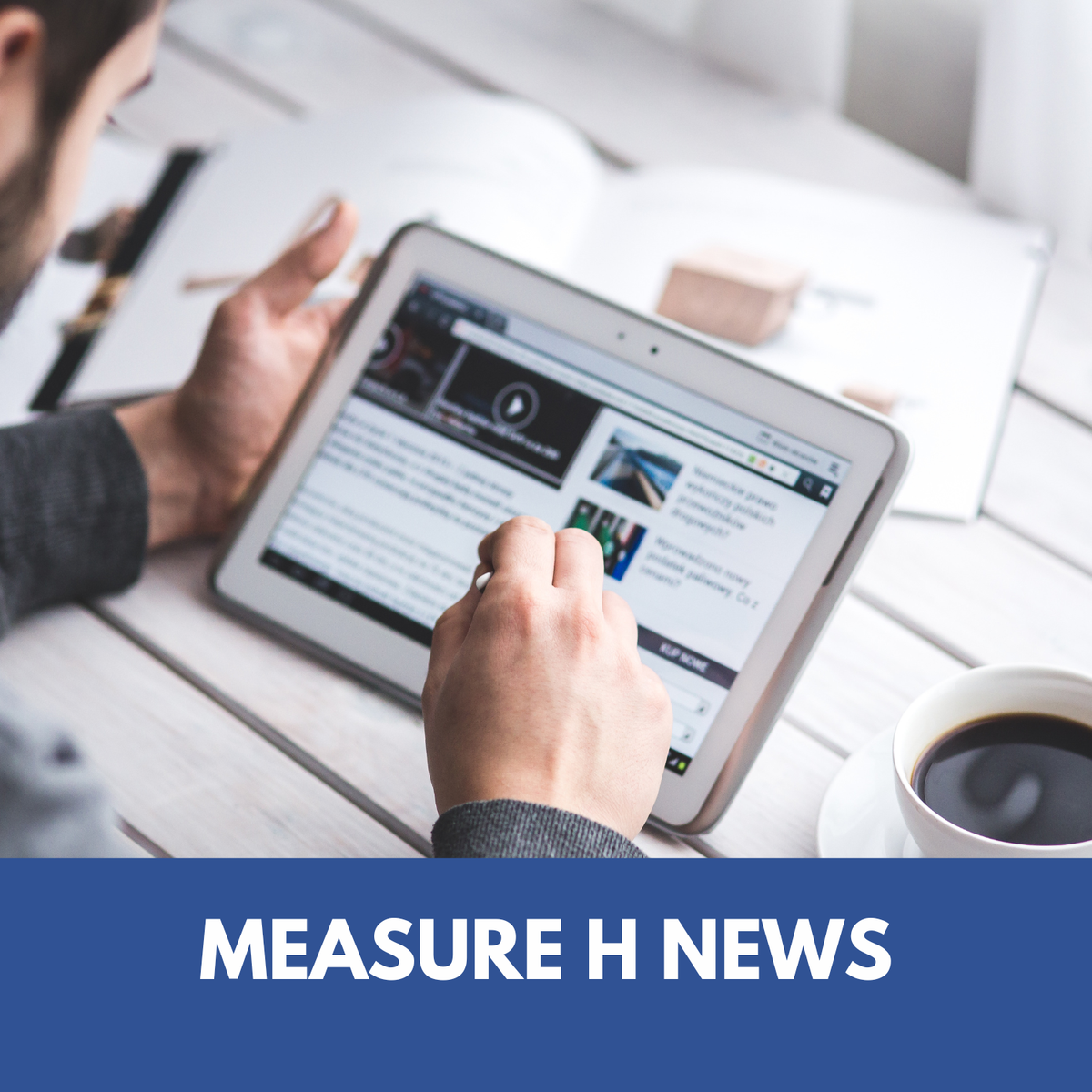 graphic design with a person's hand holding a tablet with electronic pencil. text on image says Measure H News