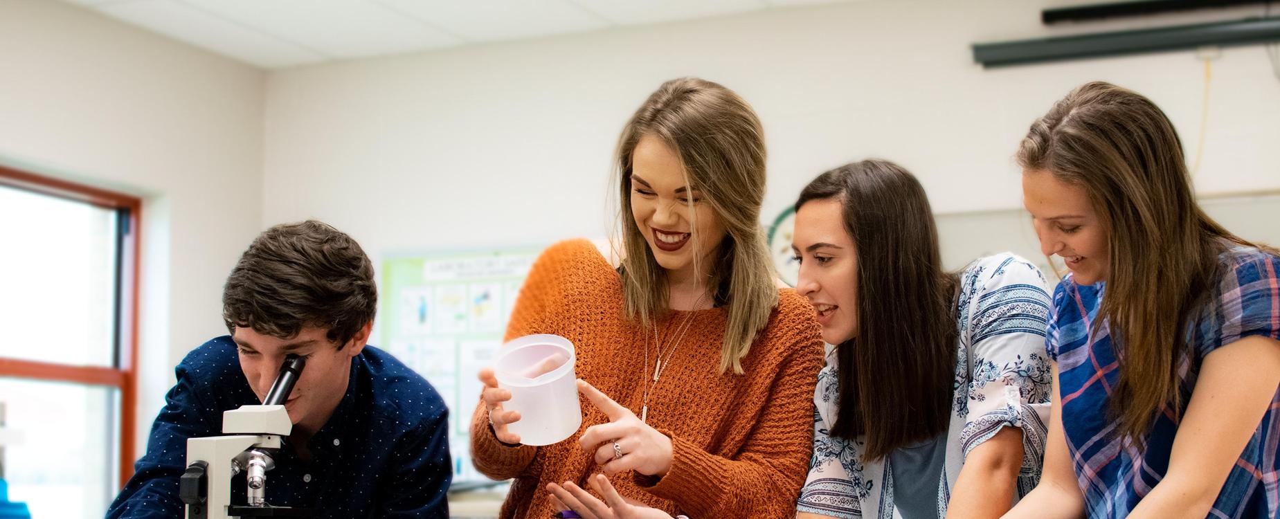Four students working on a science experiment.