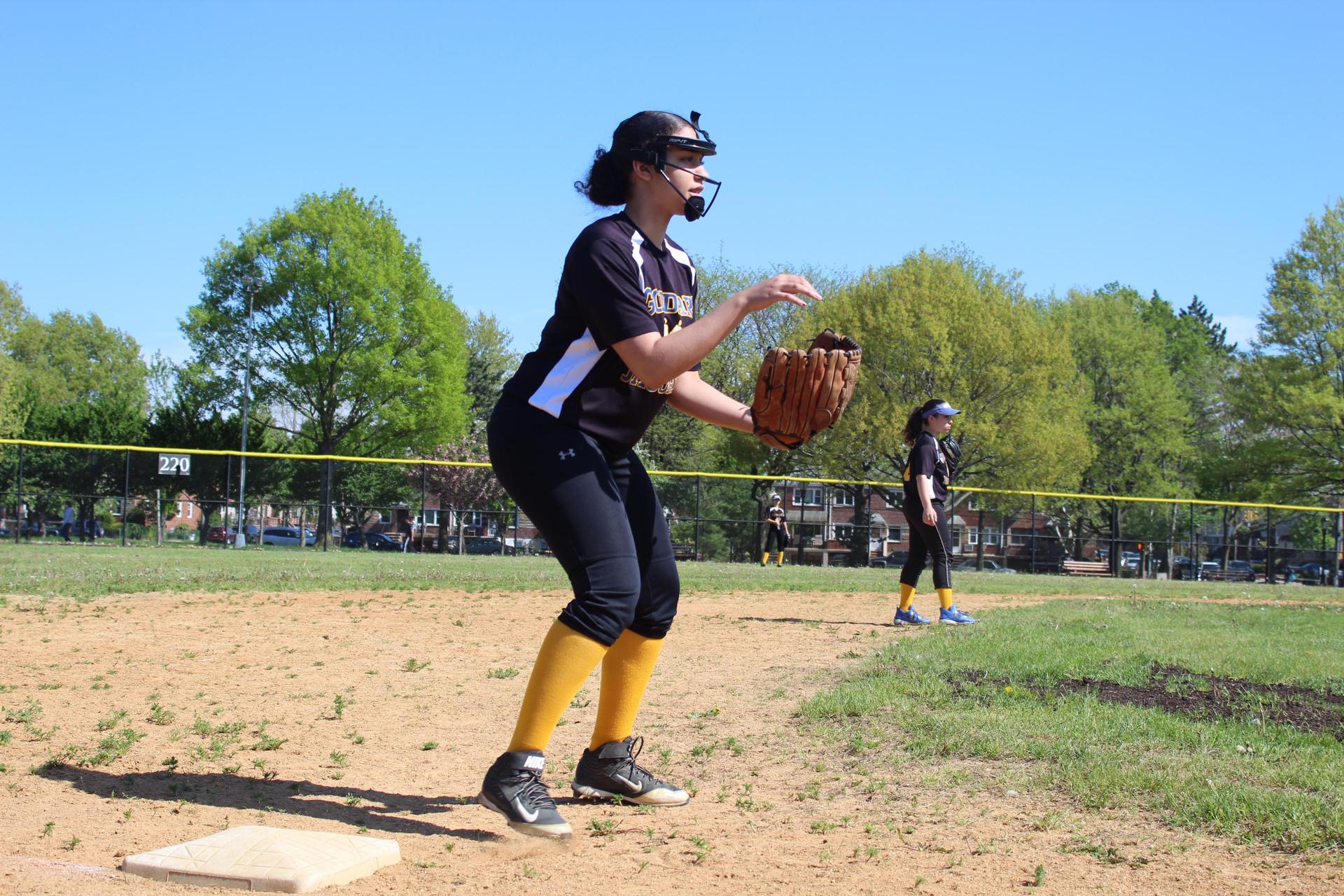 Student in softball uniform catching ball