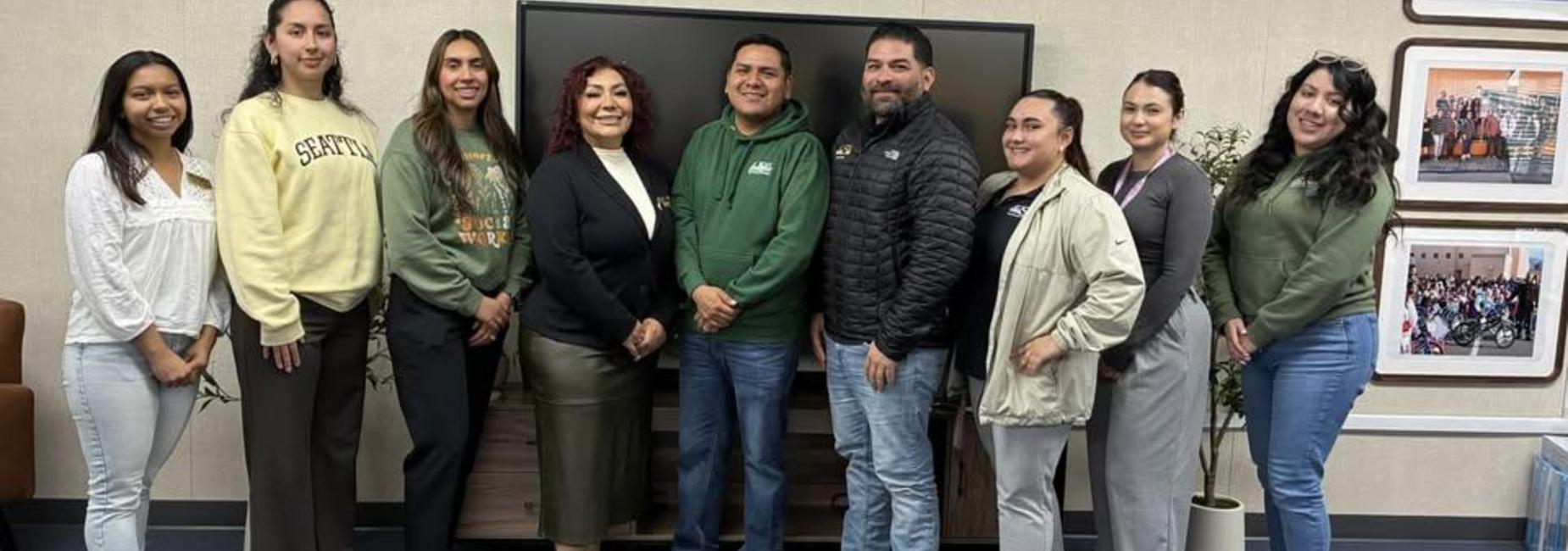 Alisal Union School District social workers standing in a room in front of a TV