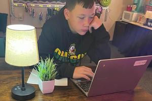 Seventh-grader Jayden Probst chooses one of the high-top tables to focus on his assignment