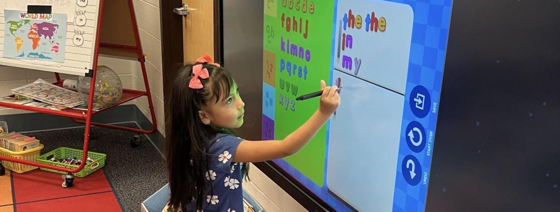 Student writing on board