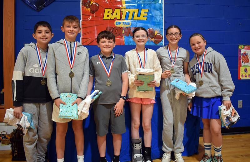 six students with prize bags posing for a picture