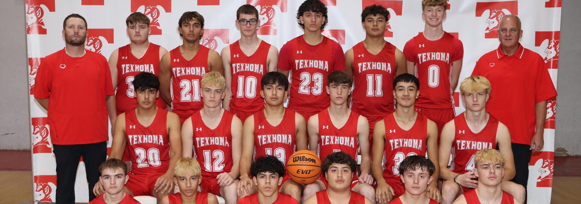 A group photo of a high school basketball team wearing red jerseys, posing with a basketball.