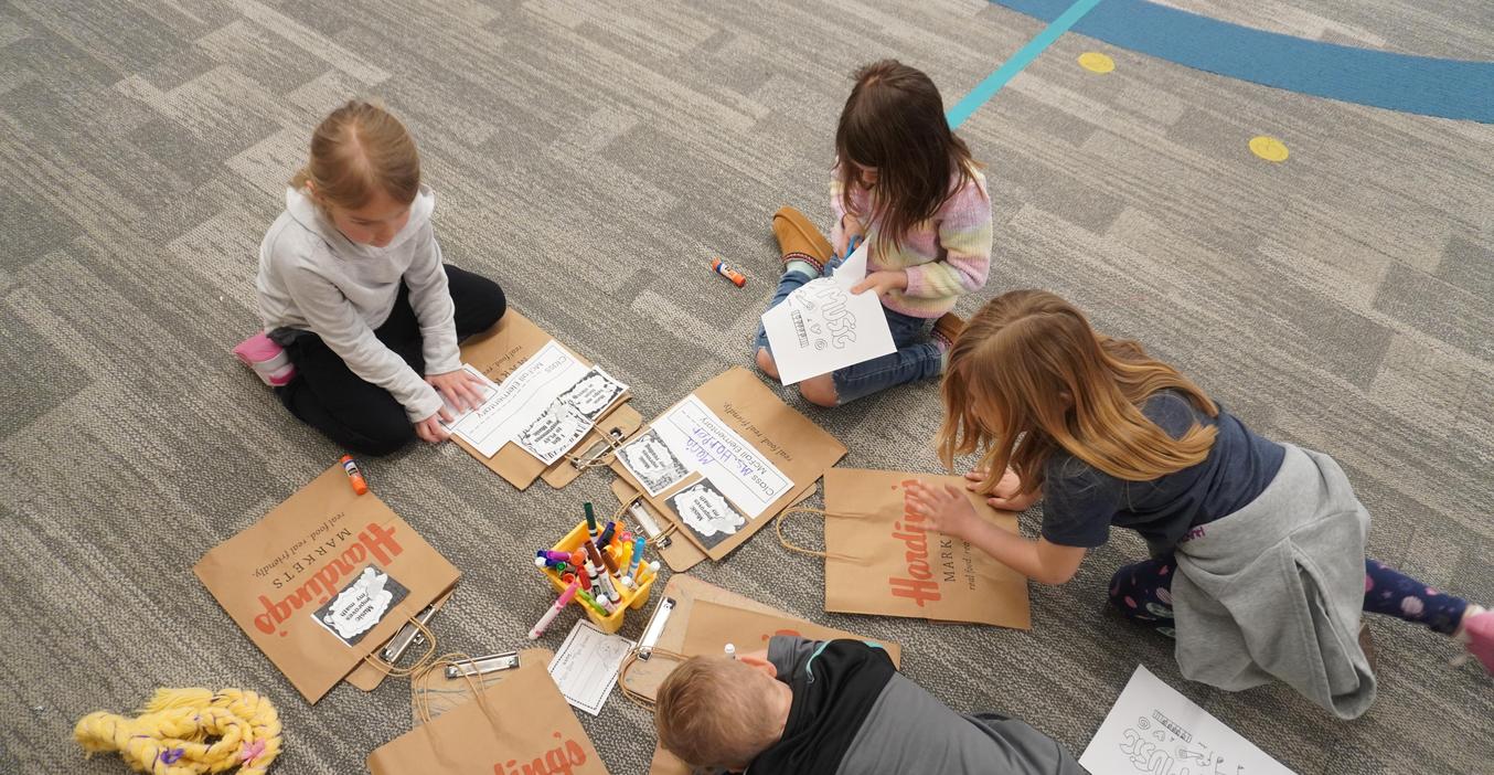 Students decorate grocery bags for music month.