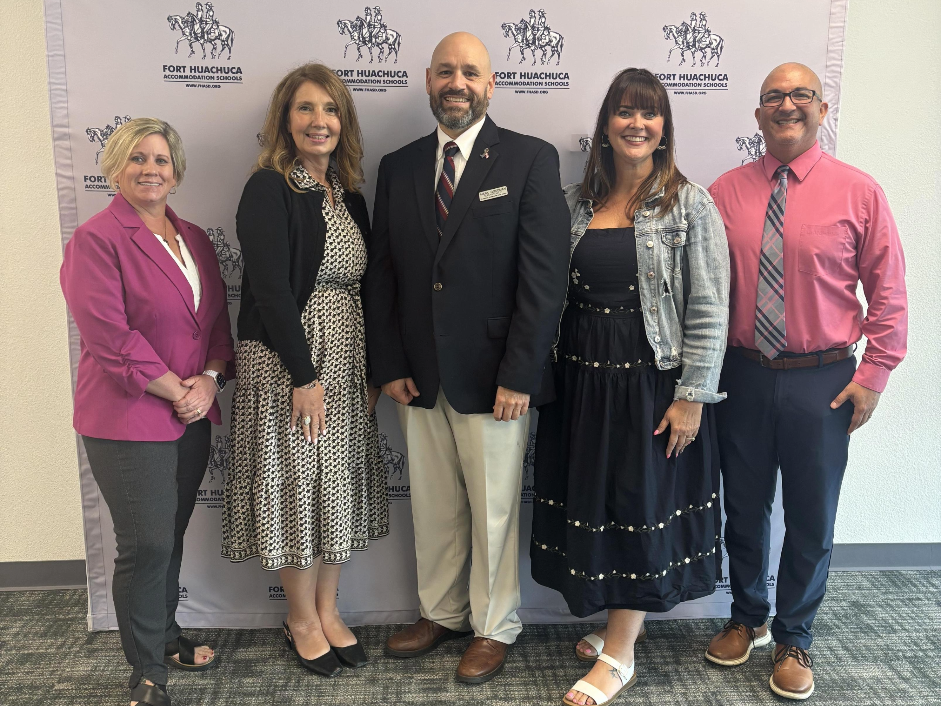 The superintendent, executive director, and principals of FHASD smiling.