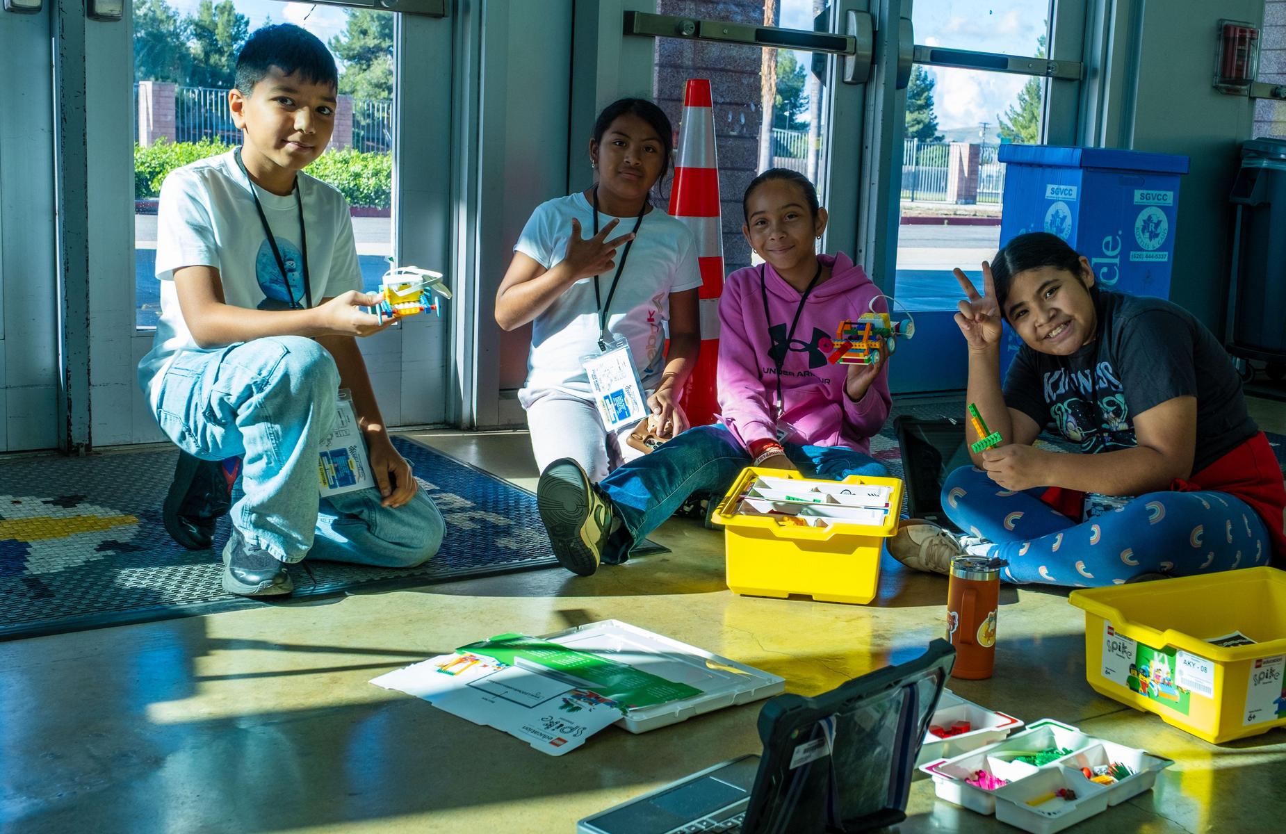 four students pose with their robots