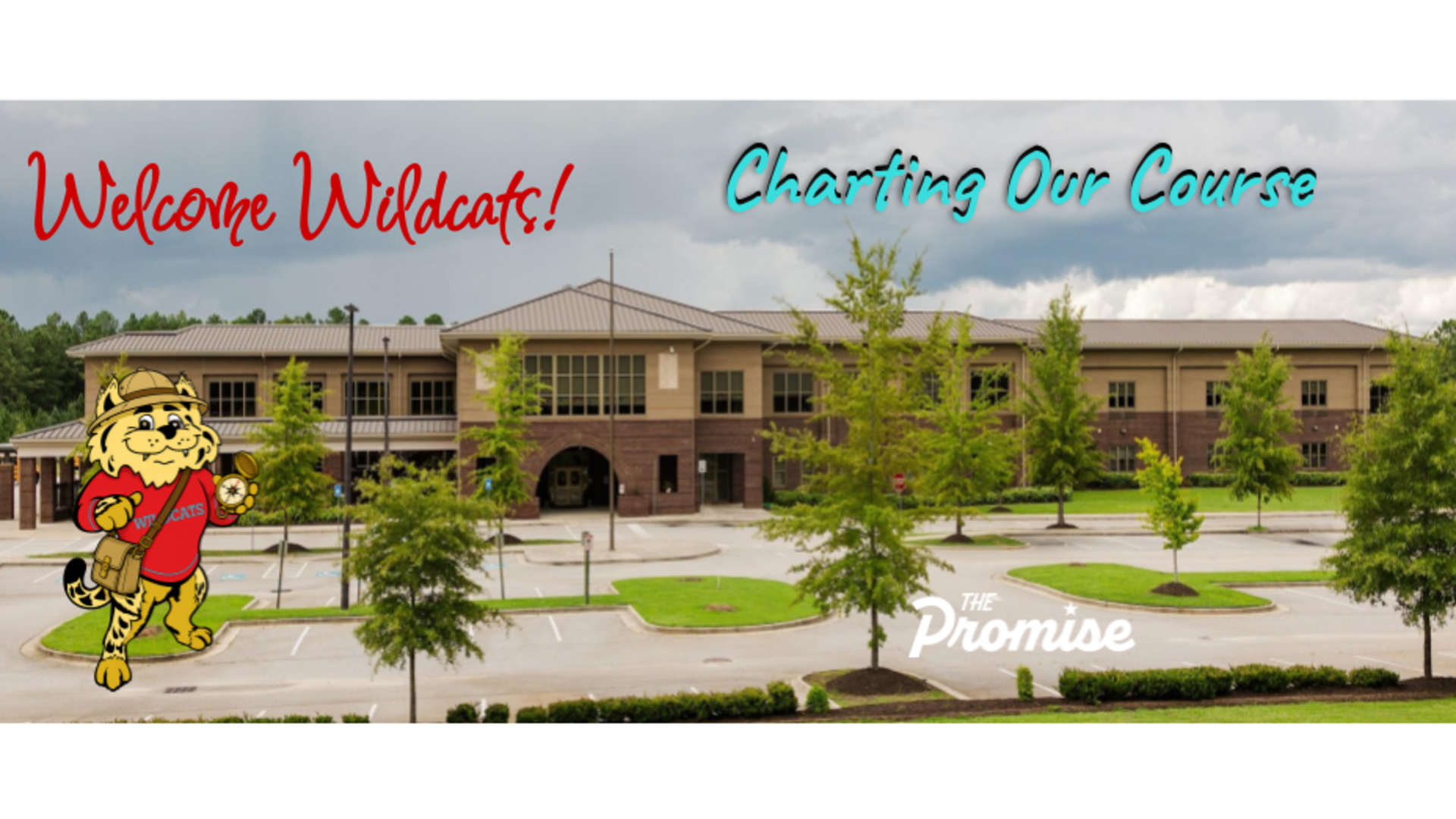 School entrance with welcoming text and mascot, showcasing the institution's focus.