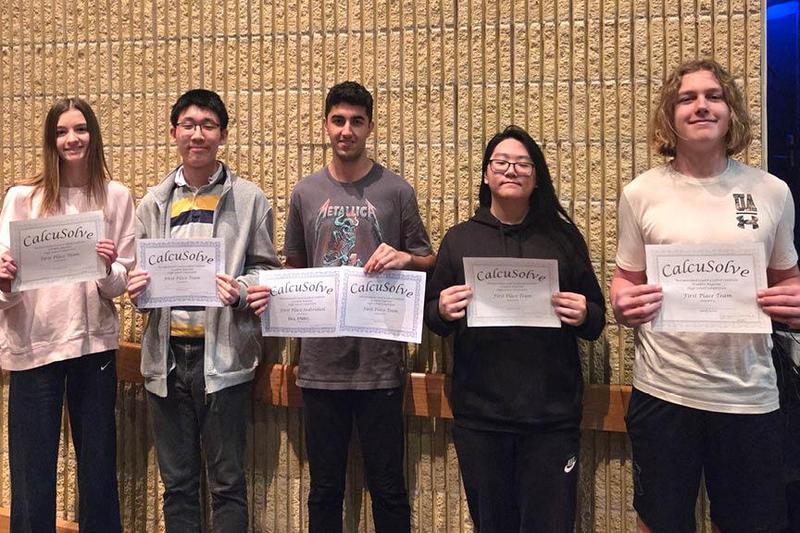 Members of the calcusolve team hold their certificate awards
