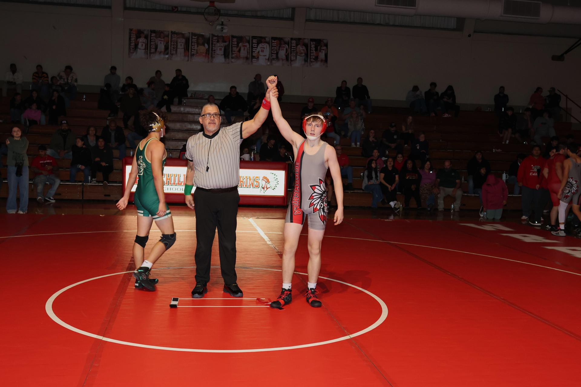 Wrestling winners with hands up 121