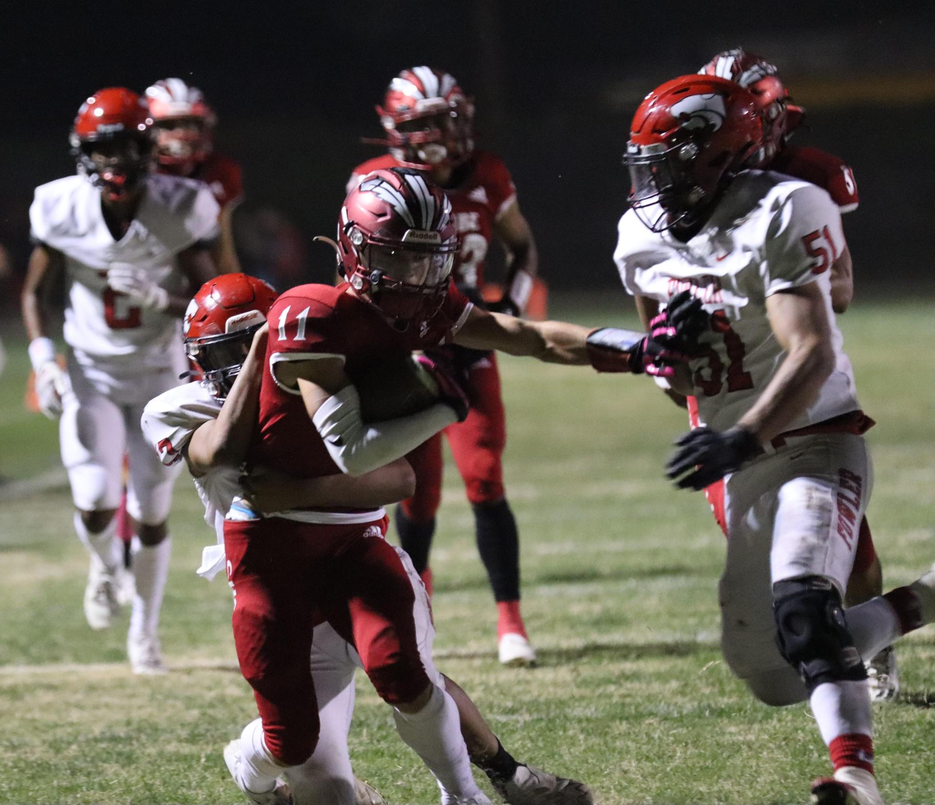 varsity boys playing football against Fowler