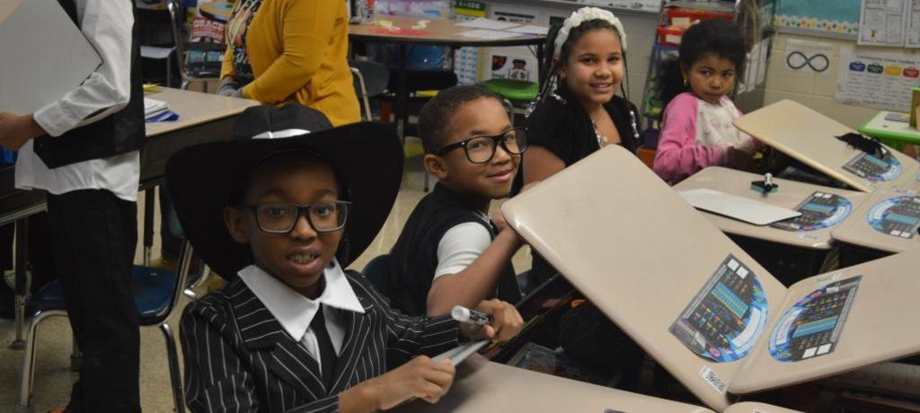four students dressed as dandies and flappers