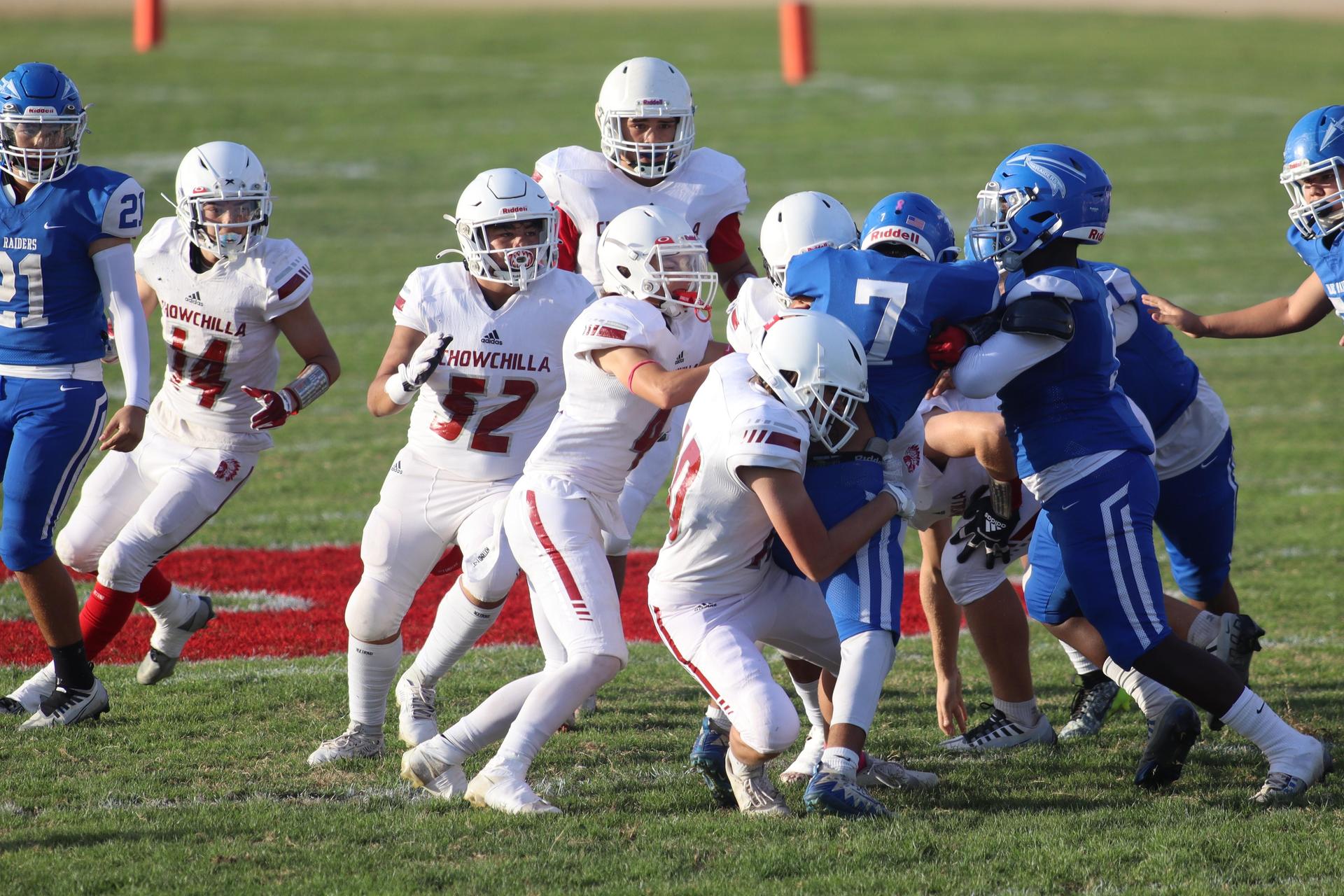 Junior Varsity football players in action against Caruthers