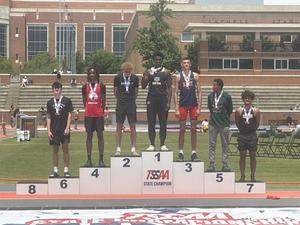 Chukwudi Obi wins state title in high jump. Pictured with young men who won 2nd thorugh 8th place.