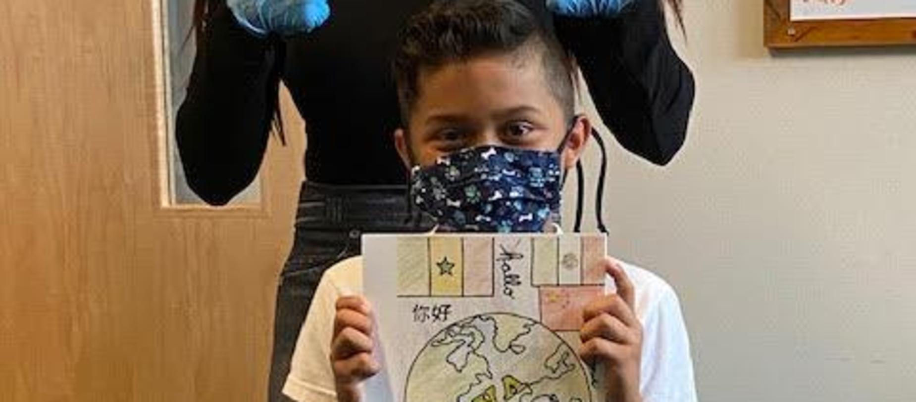 Student , 4th grade GVA Student Ruben E., with Yearbook Cover He Created!