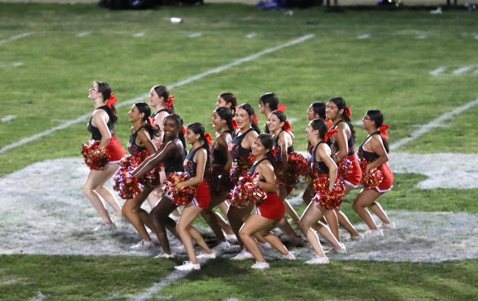 Varsity girls cheering at the Parlier football game