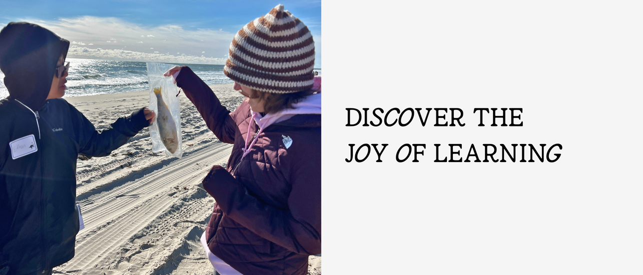 Two people on a beach holding a fish, with a motivational text beside them.