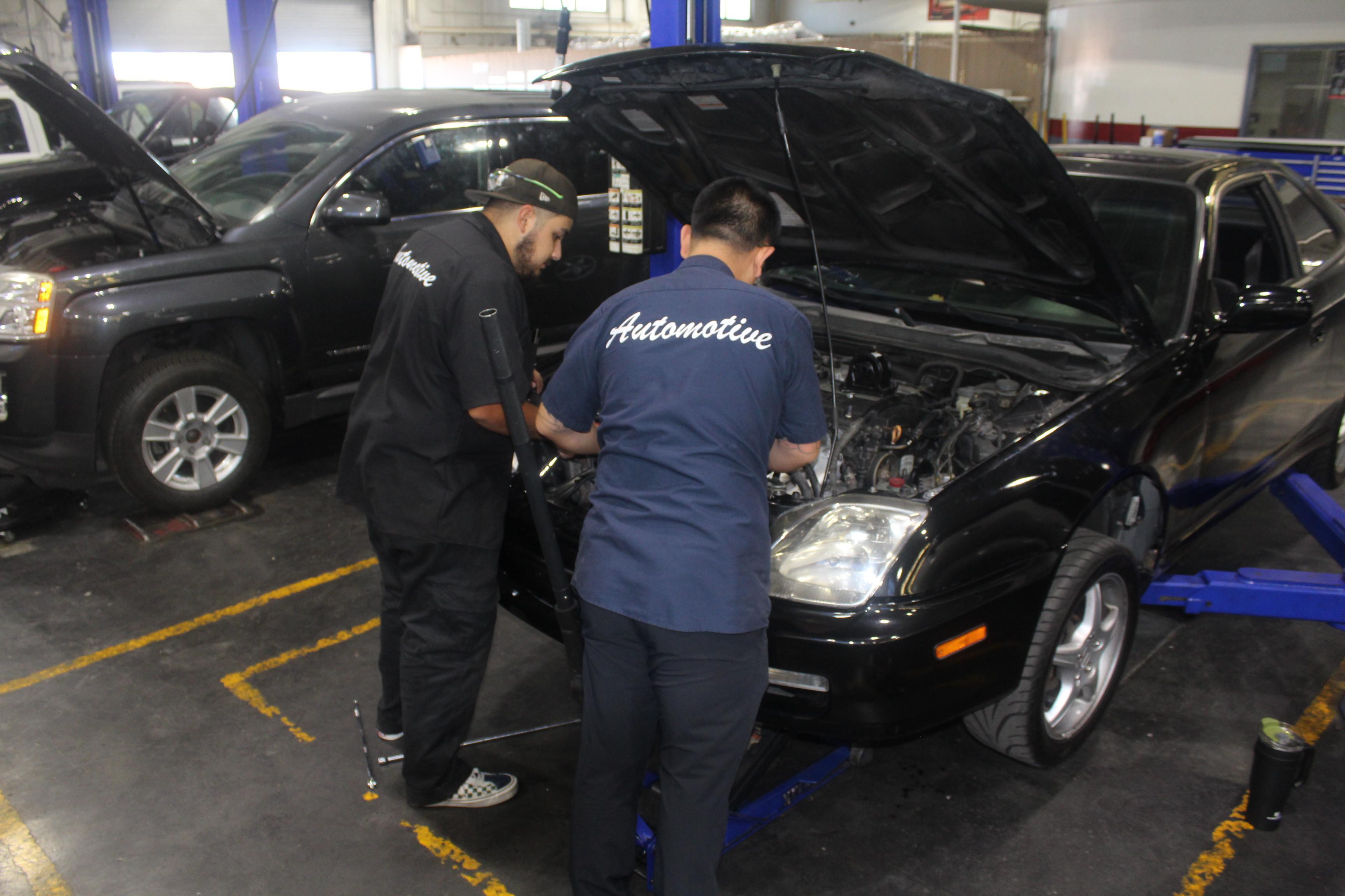 People working on a car