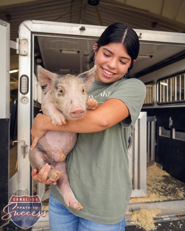 Canyon Lake High School senior Madyson Morales holding her pig.