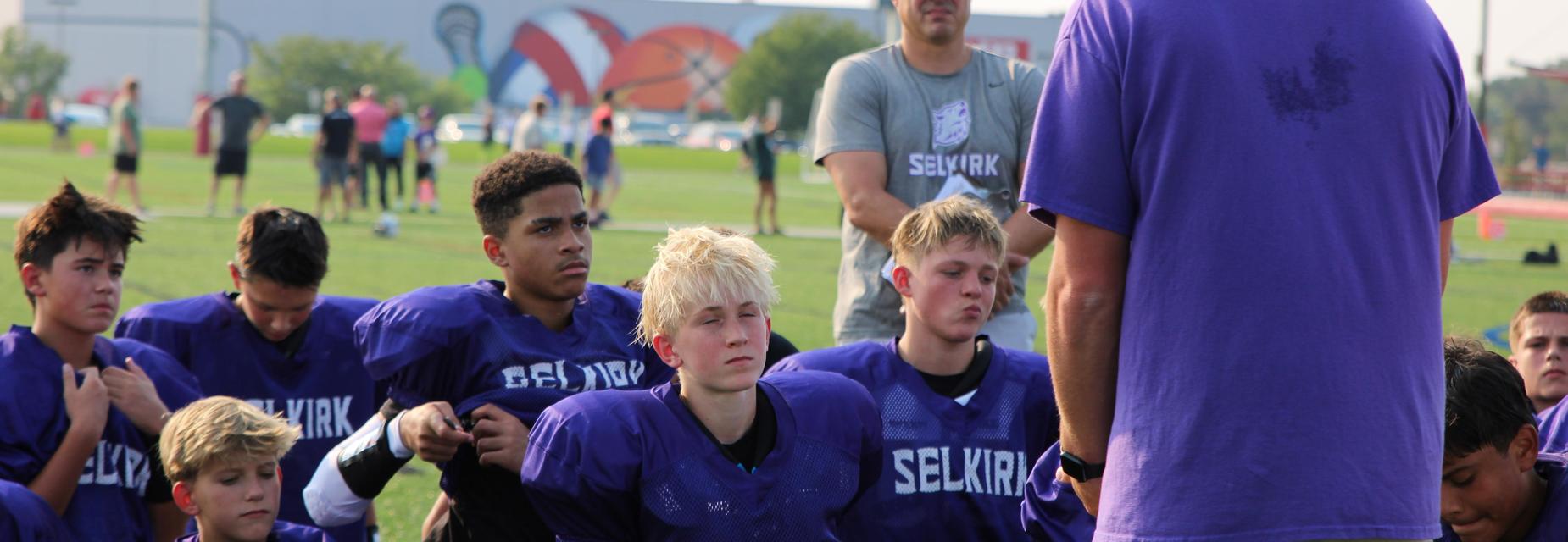 football team listening to coach at half
