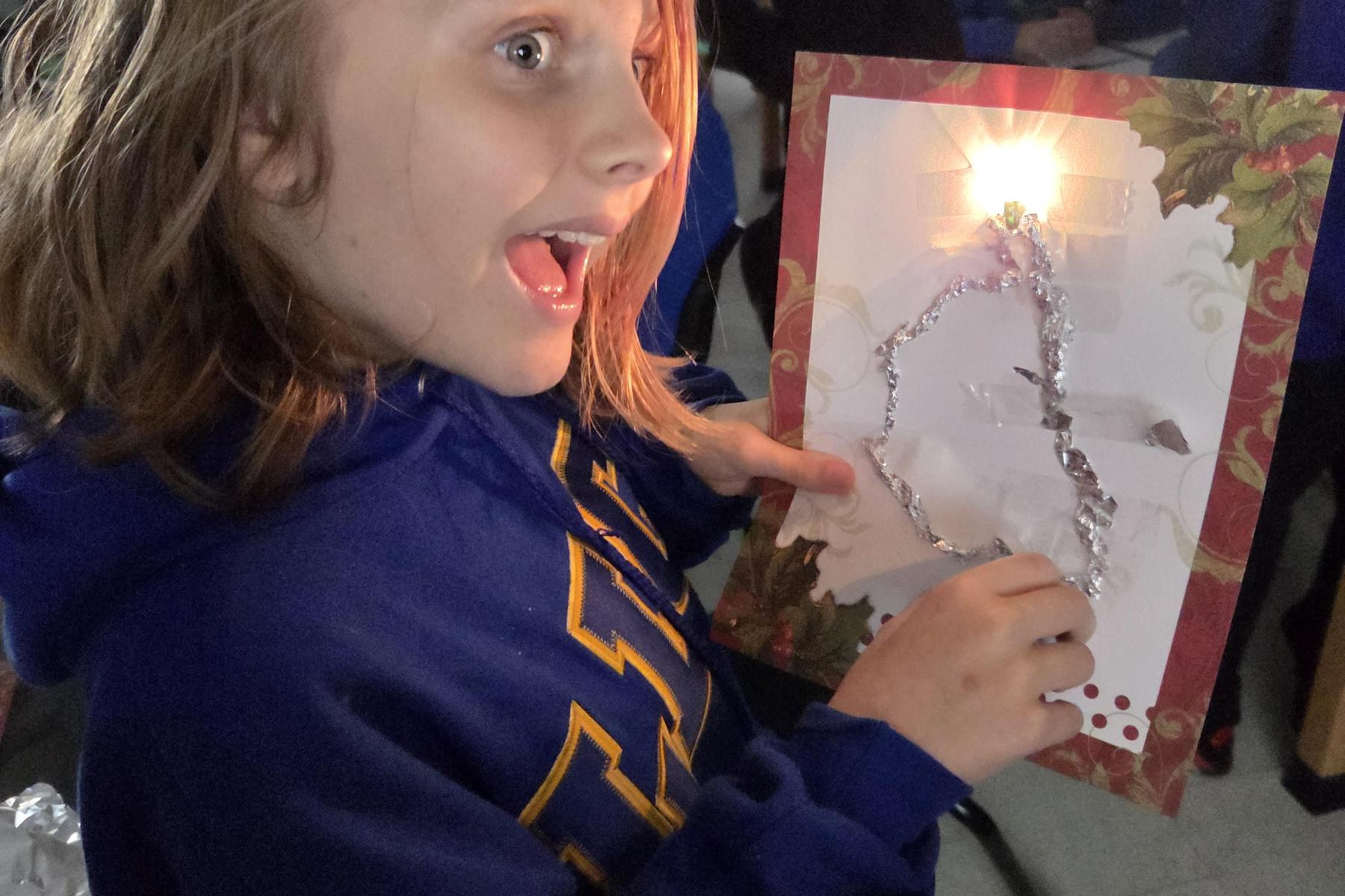 Middle School student excited about electric circuit.