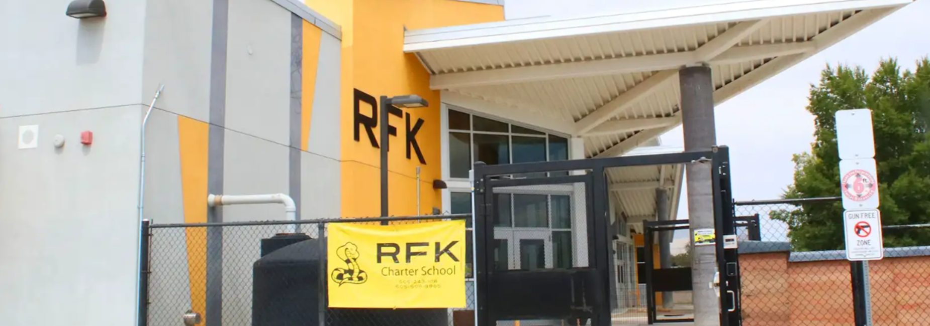 Exterior view of RFK Charter School with a yellow and gray facade.