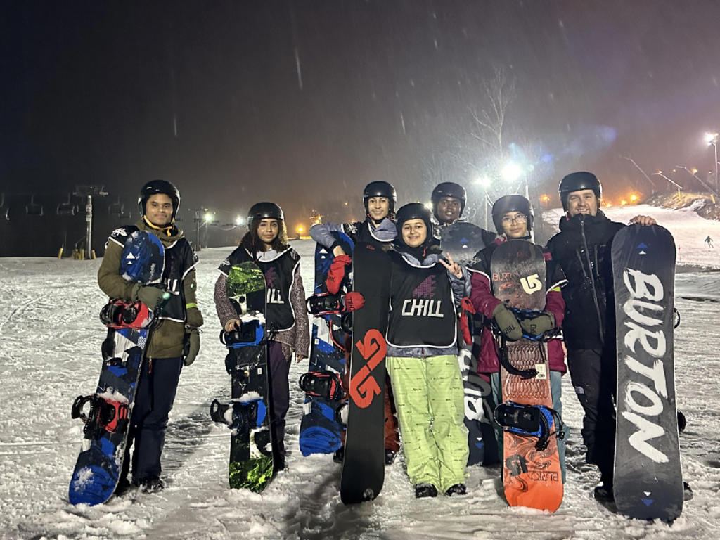 Students pose with their snowboards