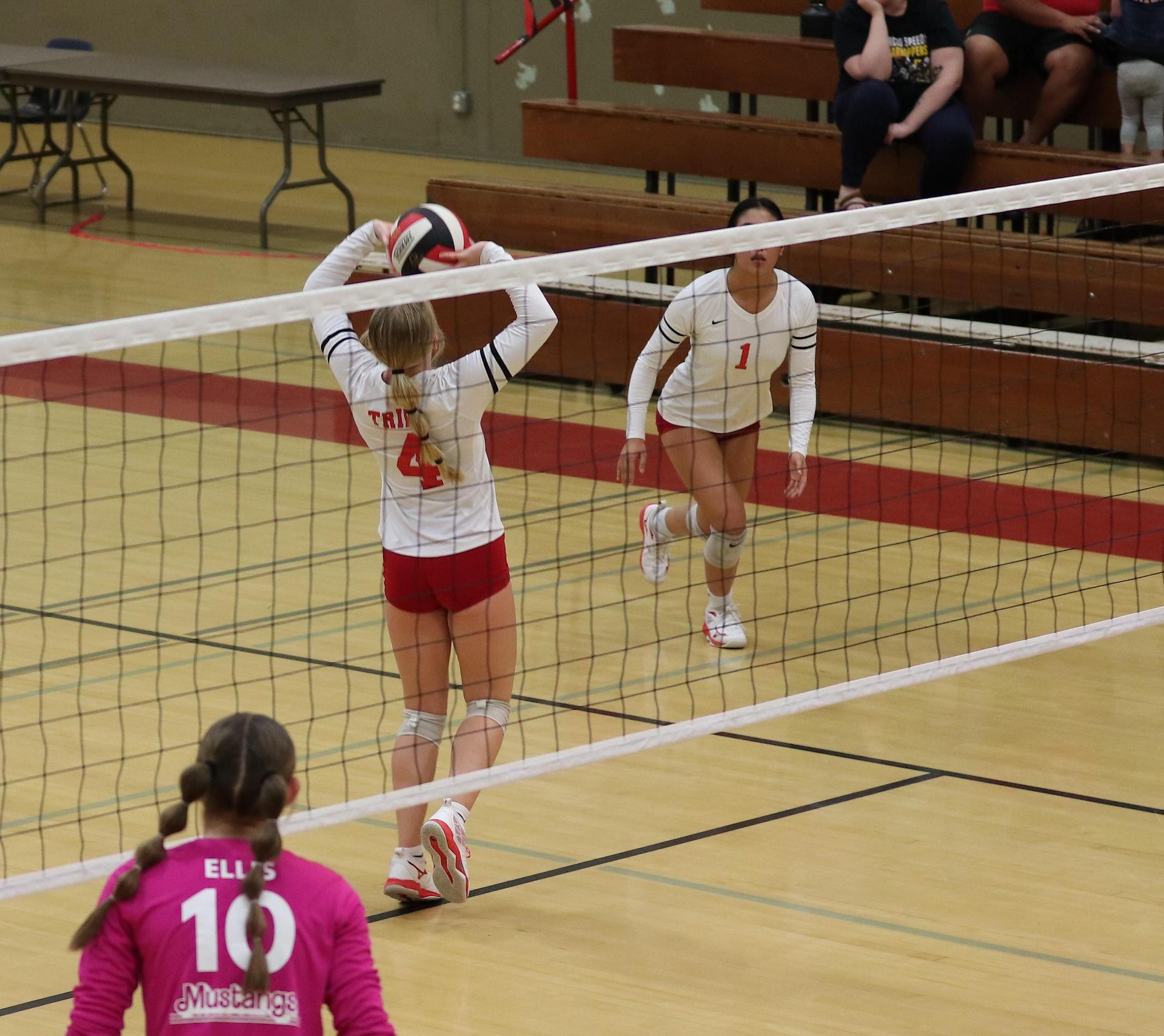 varsity volleyball players in action against Minarets