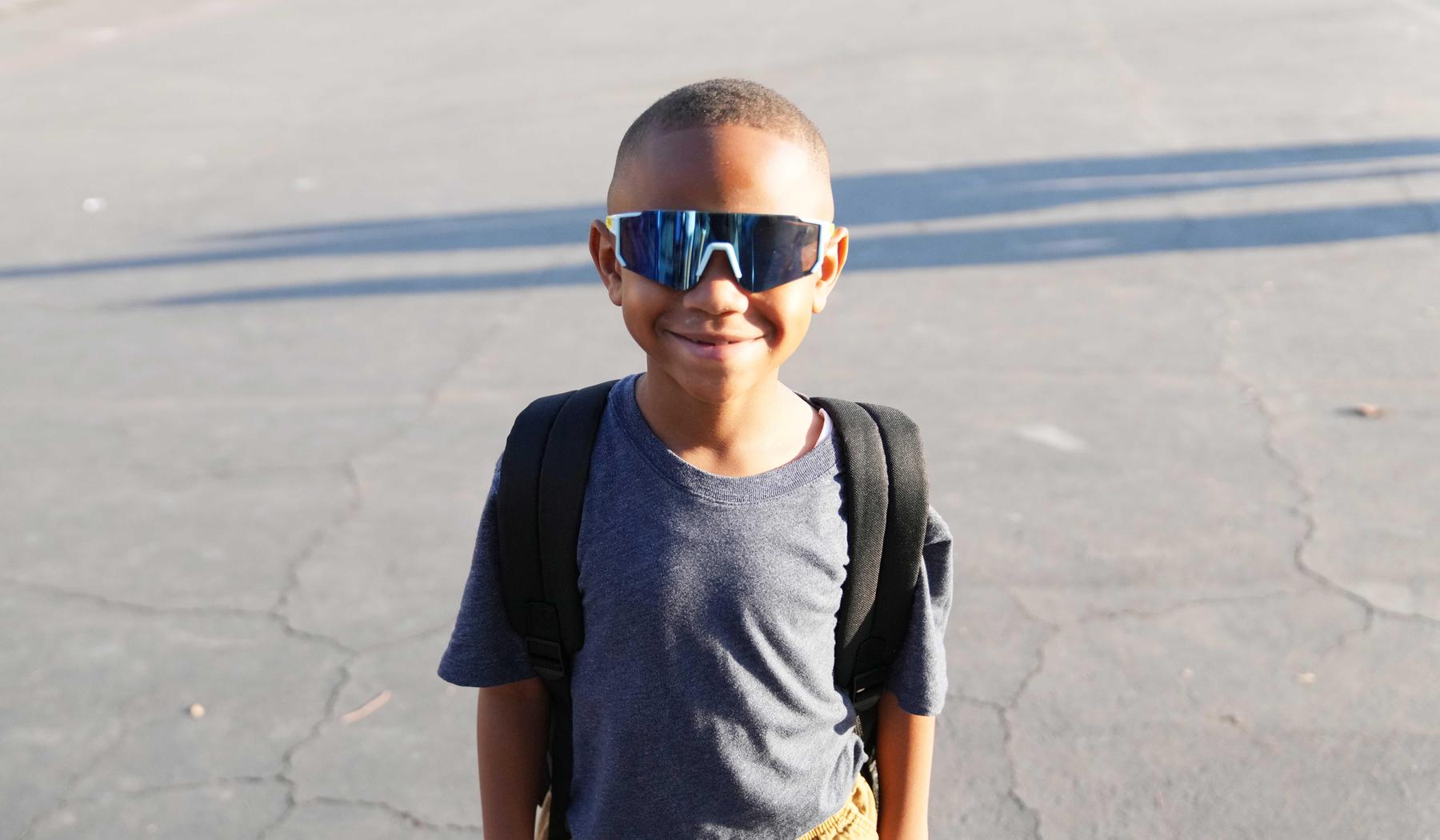 smiling boy with sunglasses