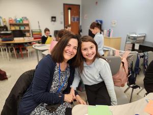 A student and a grandmother pose