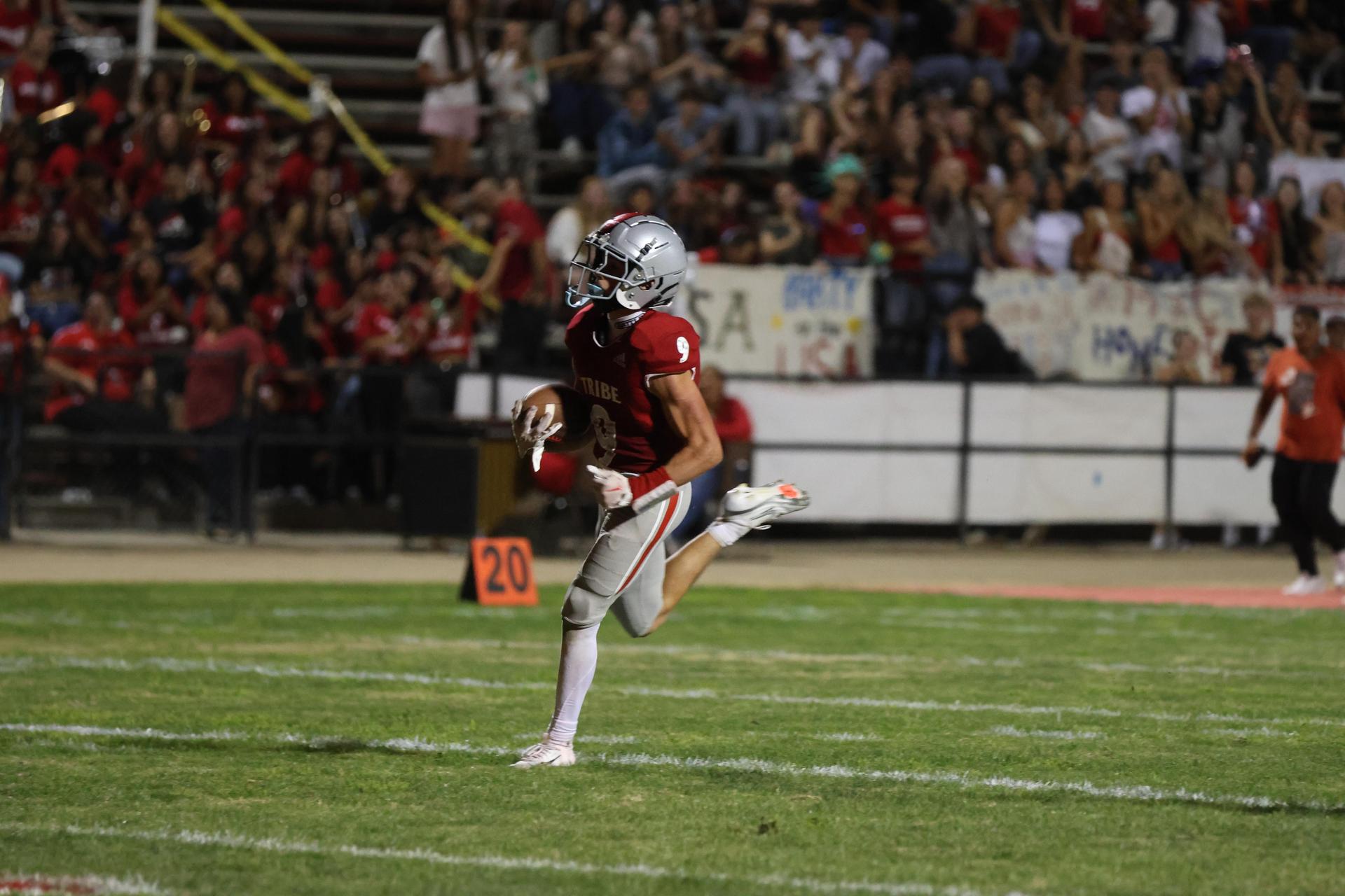 Varsity football players in action against Parlier 54