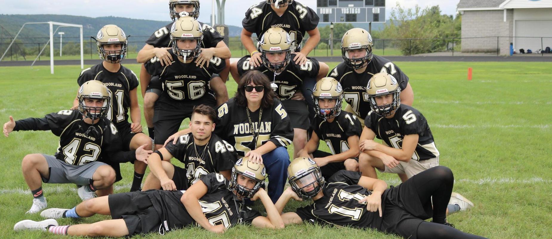 Image of teacher and football players