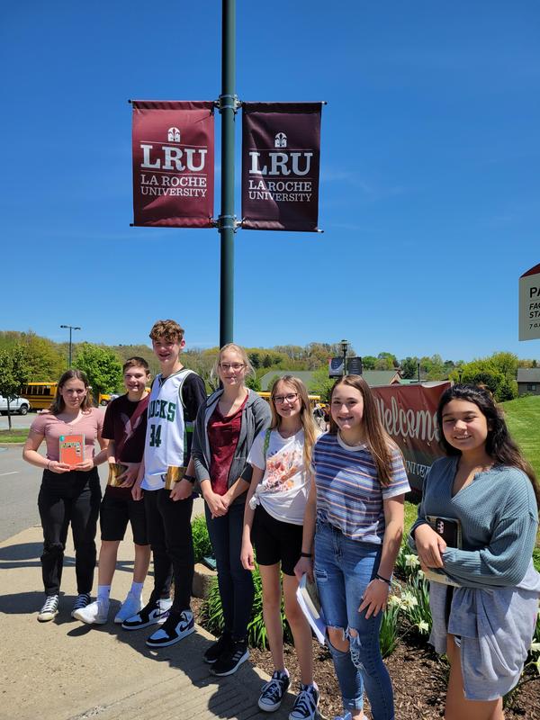 picture of students standing under an LRU flag