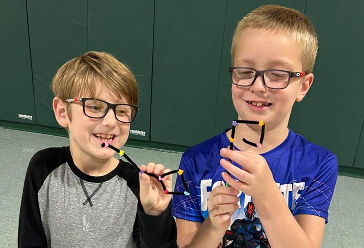 Trafford Elementary Third-graders Cyrus Vincent and Ben Gable show their finished crafts during space club