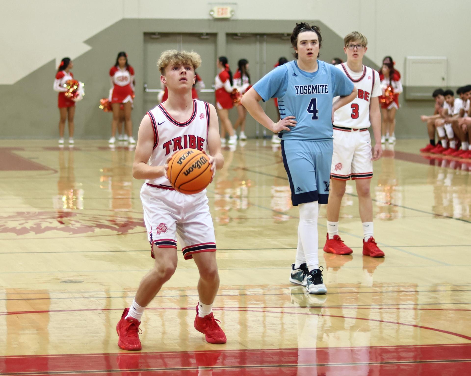 Varsity boys playing basketball against yosemite