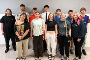 Students smile as they pose for a group picture.
