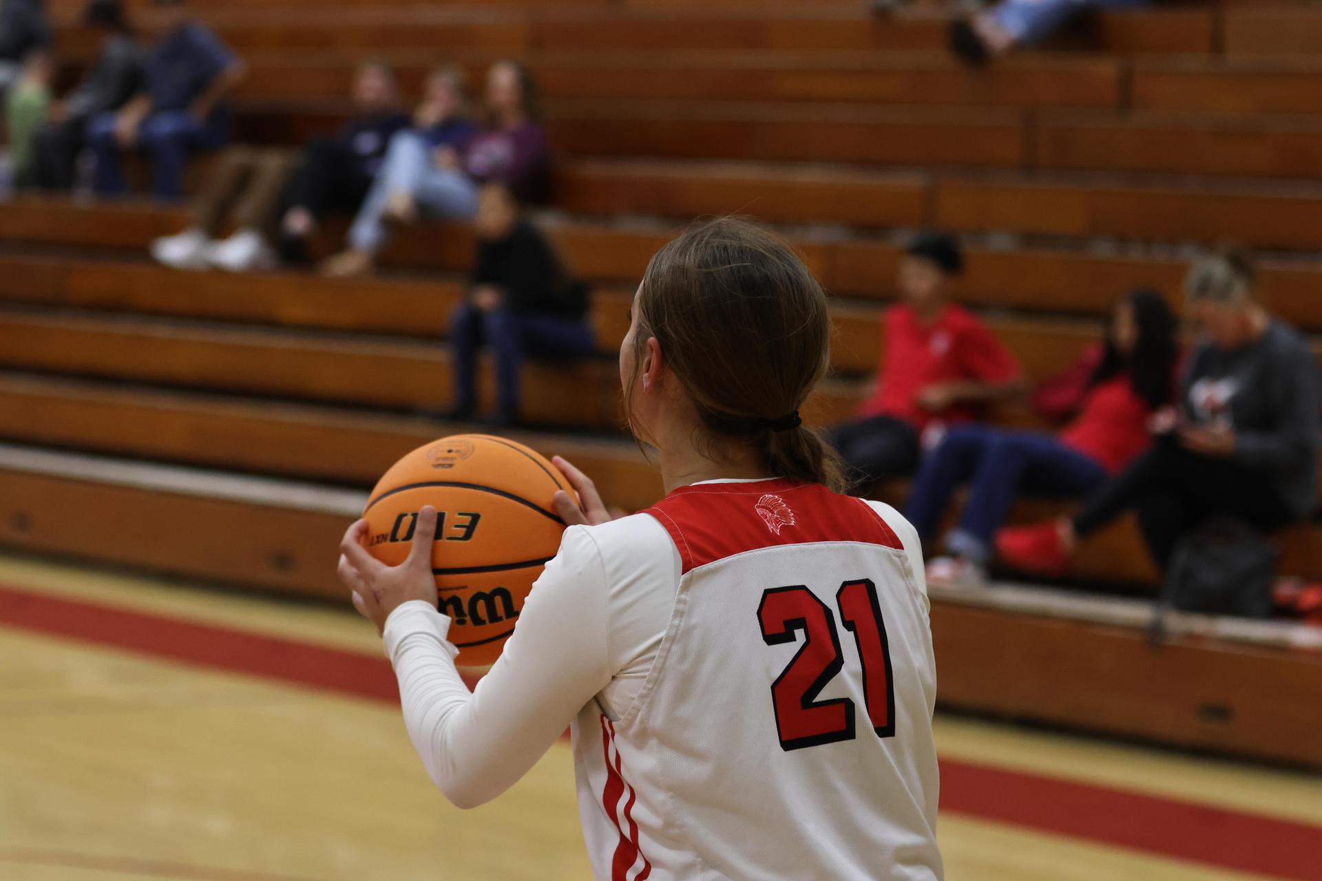 varsity girls playing basketball against mclane