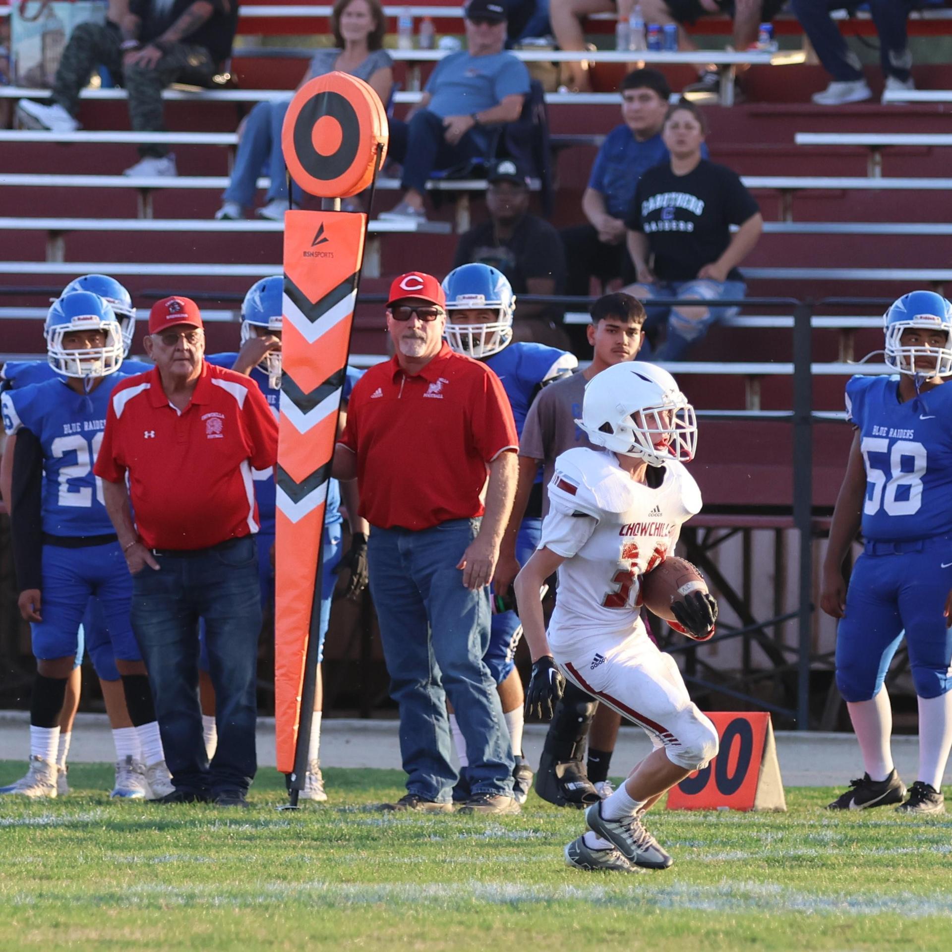 Junior Varsity football players in action against Caruthers