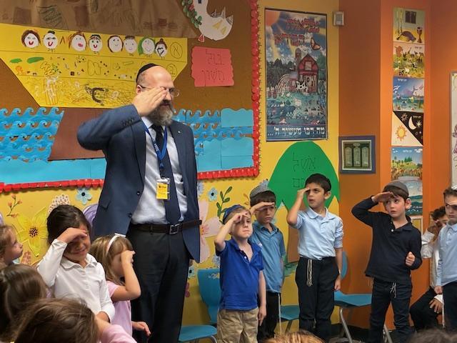 Rabbi Bram shows students how to salute