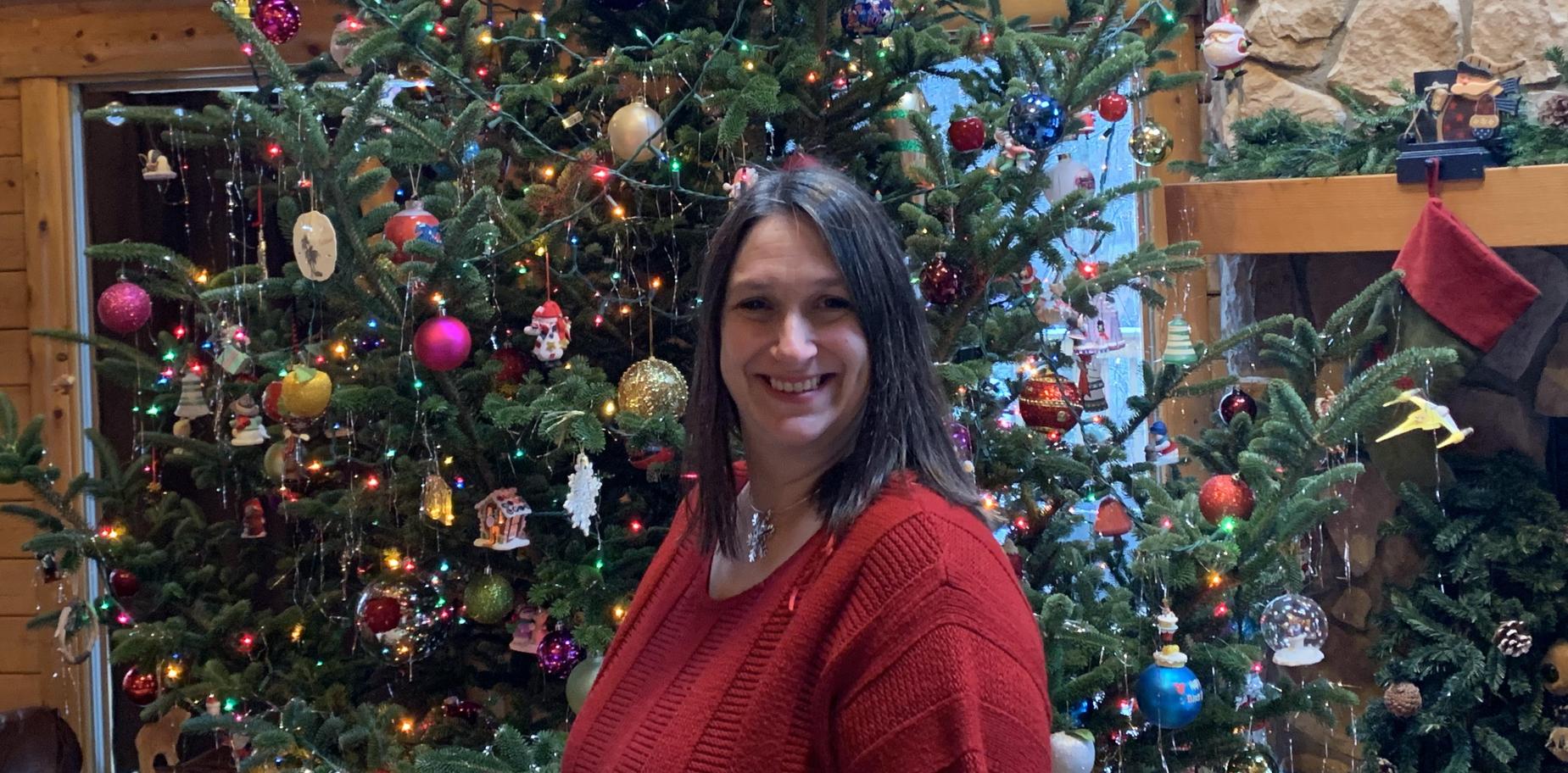 pic of Mrs. Archer in front of her Christmas tree