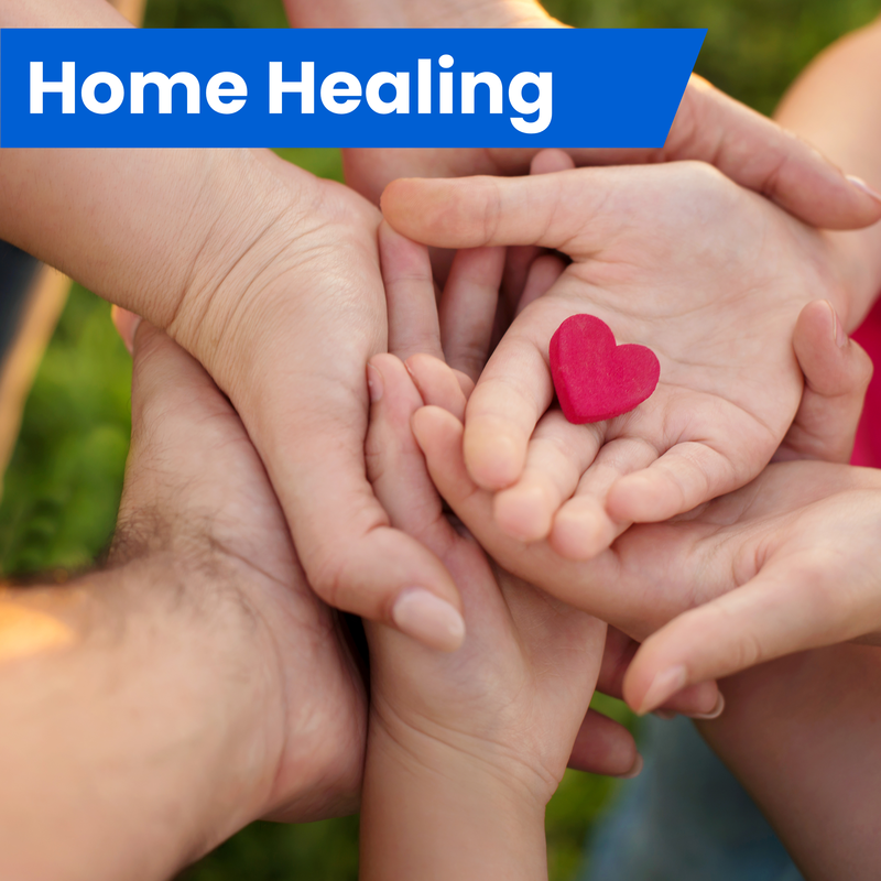 An image of hands from a family holding a heart.