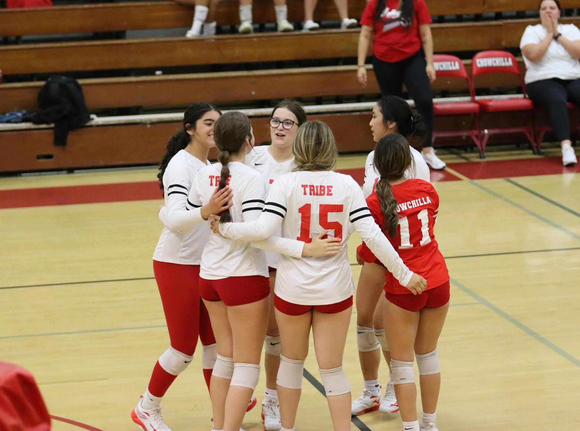 varsity volleyball players in action against liberty