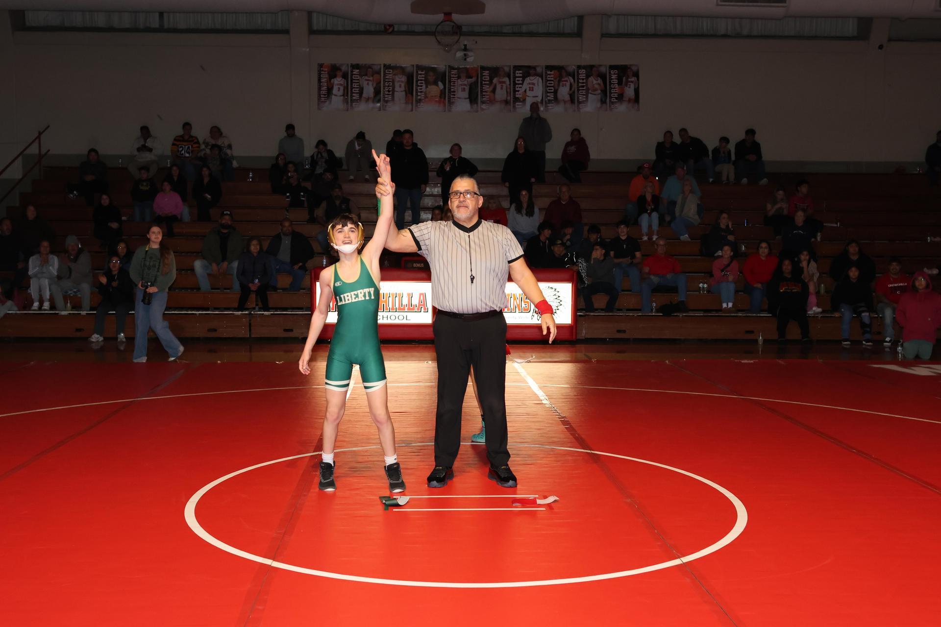 Wrestling winners with hands up 135