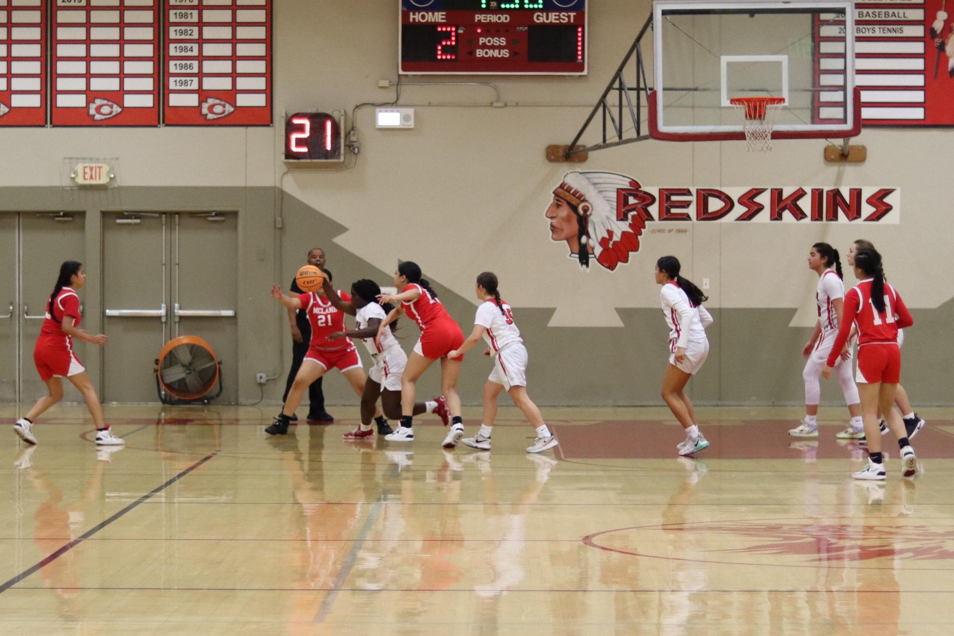varsity girls playing basketball against mclane