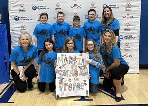 a group of students and teachers wearing blue t-shirts