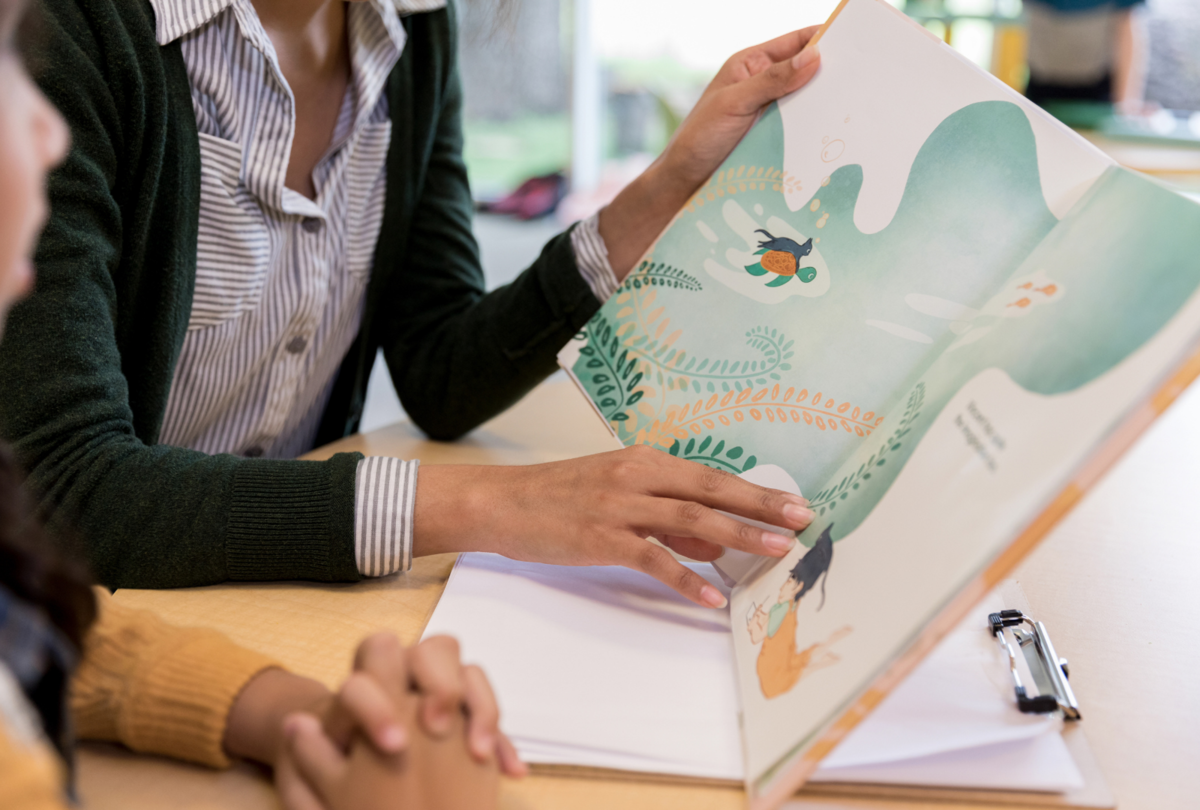 woman reading book to child