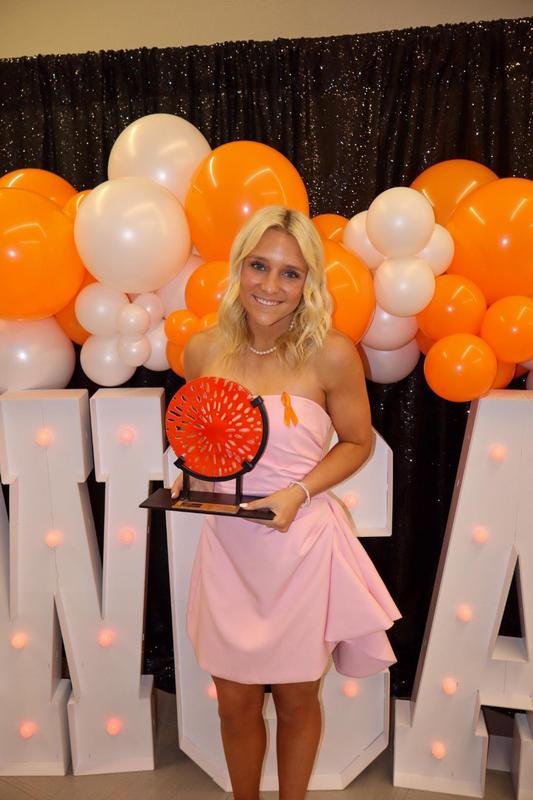 Brinkley Coker posing with award at YWCA Women of Excellence Awards Banquet