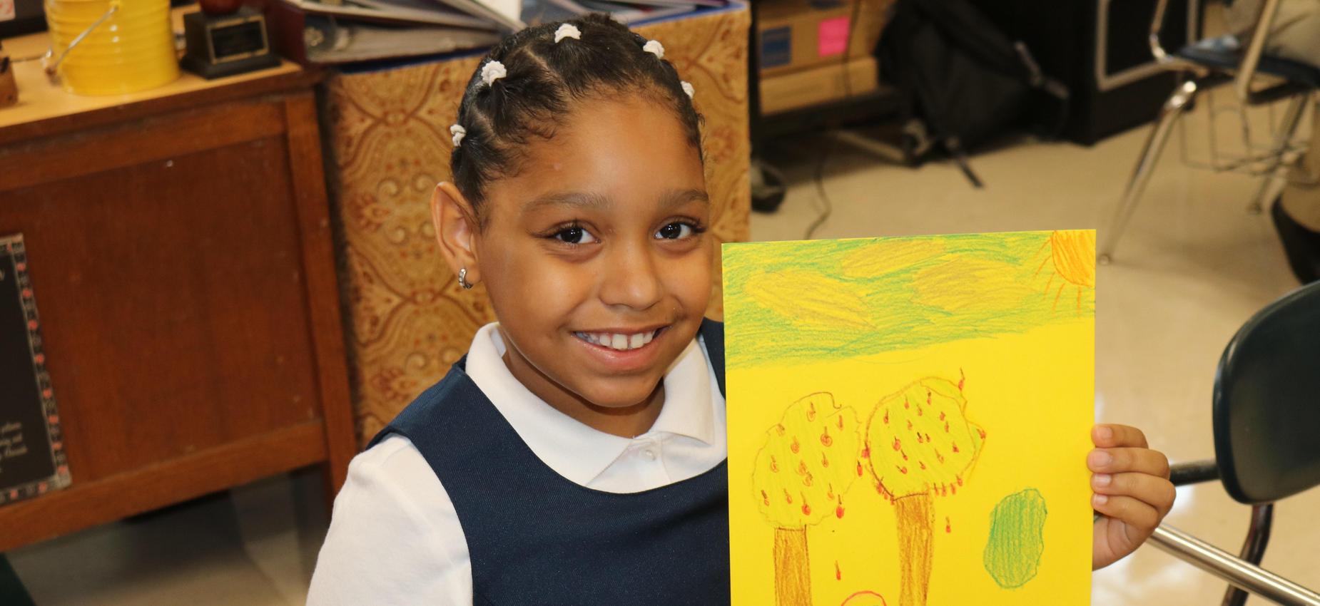 student showing off work