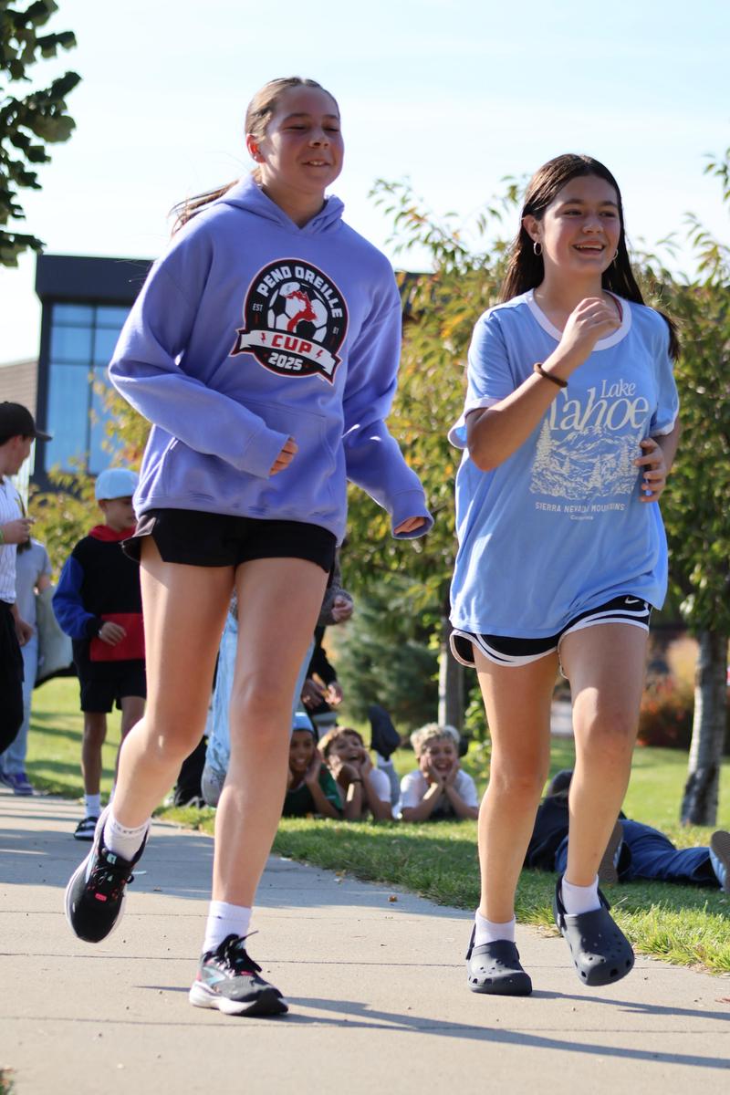 Girls running on sidewalk