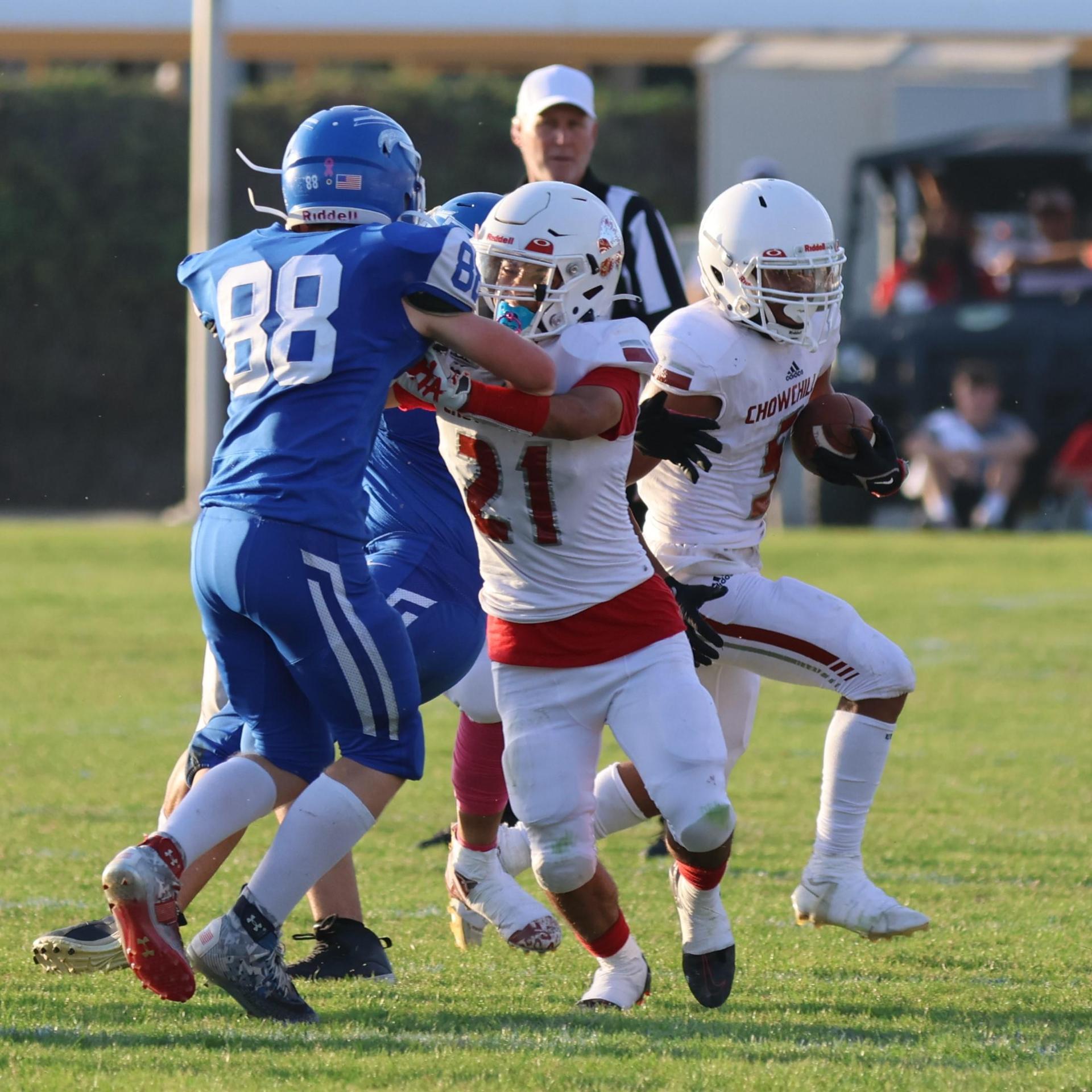 Junior Varsity football players in action against Caruthers